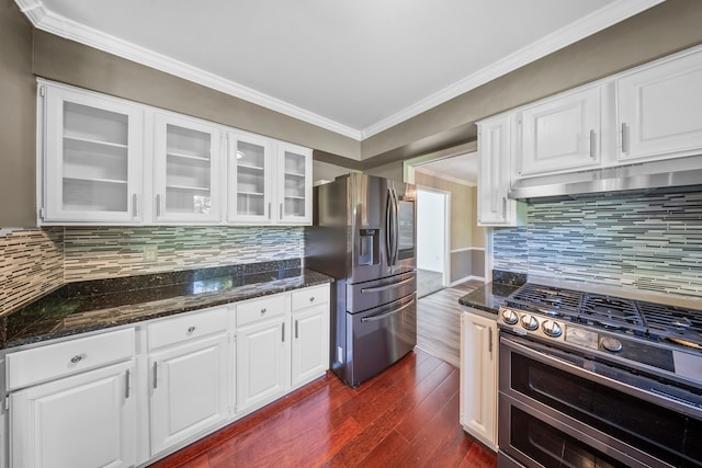 18080 Parke Ln, Grosse Ile, MI 48138 - kitchen with stainless steel appliances, under cabinet range hood, dark wood-style floors, ornamental molding, and dark stone counters