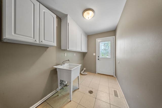 18080 Parke Ln, Grosse Ile, MI 48138 - laundry room featuring baseboards and light tile patterned flooring