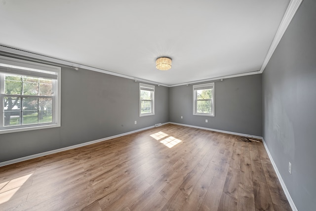 18080 Parke Ln, Grosse Ile, MI 48138 - spare room with ornamental molding, hardwood / wood-style floors, and baseboards