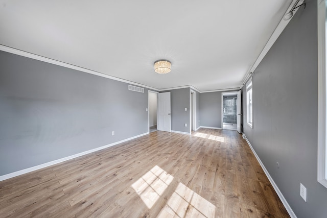 18080 Parke Ln, Grosse Ile, MI 48138 - spare room featuring ornamental molding, wood finished floors, and baseboards