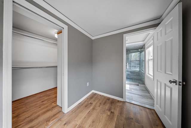 18080 Parke Ln, Grosse Ile, MI 48138 - unfurnished bedroom featuring ornamental molding, wood finished floors, a closet, and baseboards