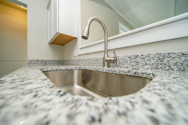 30644 Hayes Rd, Roseville, MI 48066 - kitchen view of a sink, white cabinets, and light stone countertops