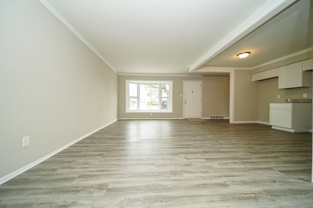 30644 Hayes Rd, Roseville, MI 48066 - unfurnished living room with baseboards, crown molding, and light wood-style flooring
