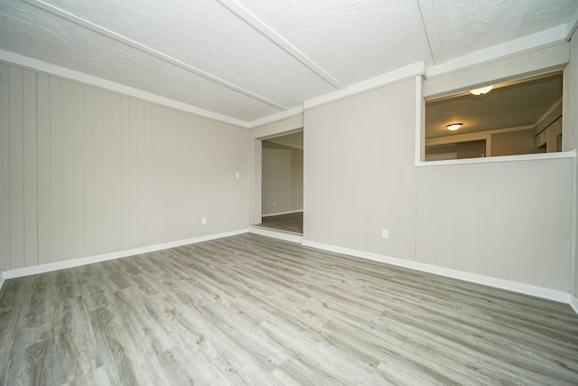 30644 Hayes Rd, Roseville, MI 48066 - spare room with wood finished floors, a textured ceiling, and baseboards