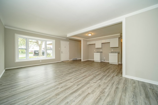 30644 Hayes Rd, Roseville, MI 48066 - unfurnished living room with light wood-type flooring, baseboards, and crown molding