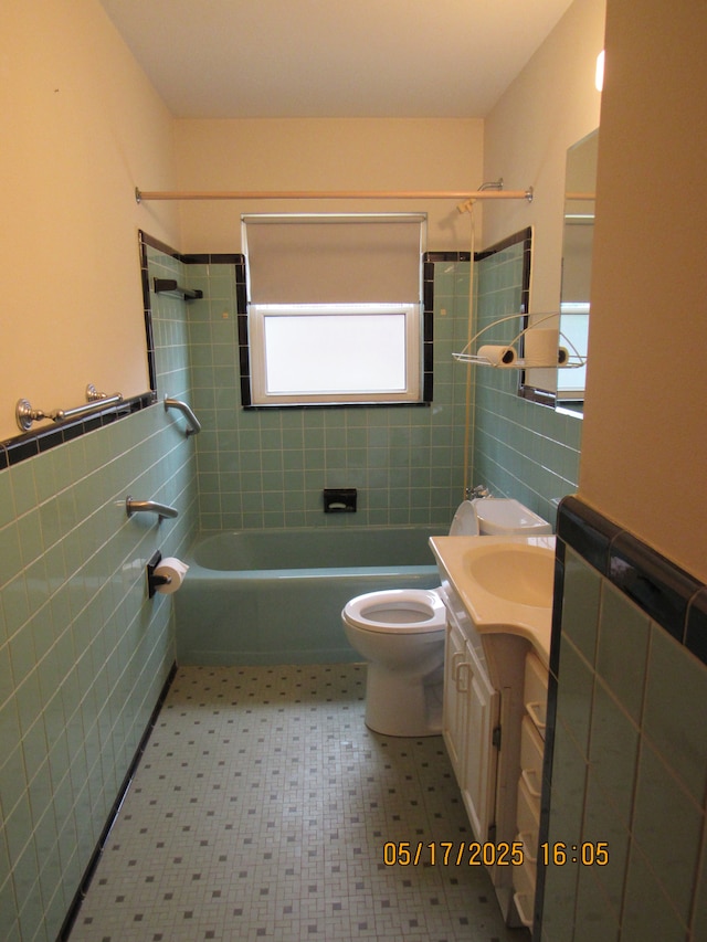 5962 Mcmillian Blvd, Dearborn Heights, MI 48127 - full bathroom with tile walls, shower / bathtub combination, toilet, vanity, and tile patterned floors