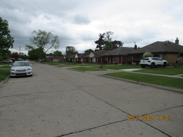 5962 Mcmillian Blvd, Dearborn Heights, MI 48127 - view of concrete road featuring curbs, sidewalks, and a residential view
