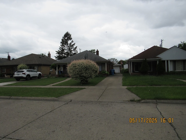 5962 Mcmillian Blvd, Dearborn Heights, MI 48127 - view of front of property with a front lawn, a garage, and driveway