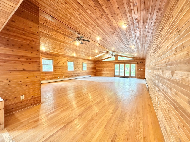 unfurnished living room with wooden walls, a ceiling fan, lofted ceiling, light wood finished floors, and wooden ceiling