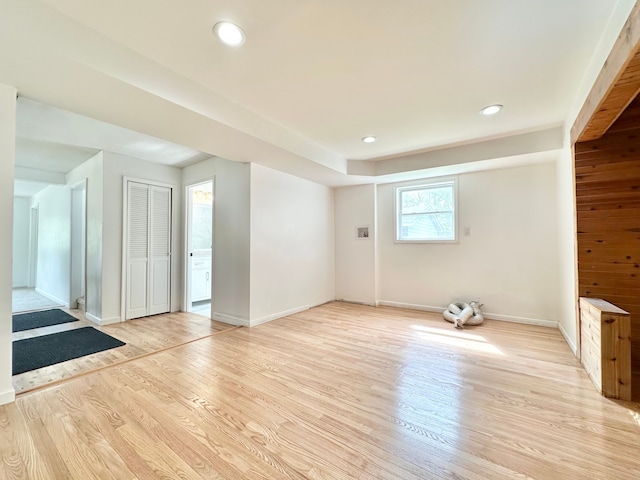 unfurnished room featuring light wood finished floors, baseboards, and recessed lighting