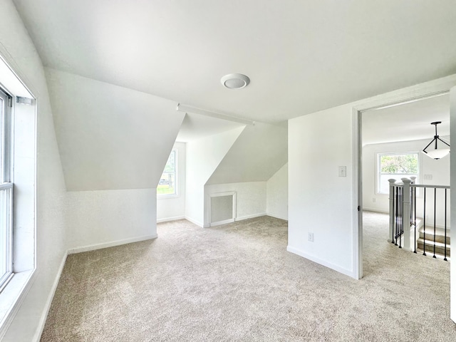 bonus room featuring carpet floors, baseboards, and lofted ceiling