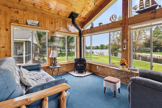 204 Crockett Dr, Quincy, MI 49082 - sunroom / solarium with a water view, lofted ceiling, a wood stove, carpet floors, and healthy amount of natural light