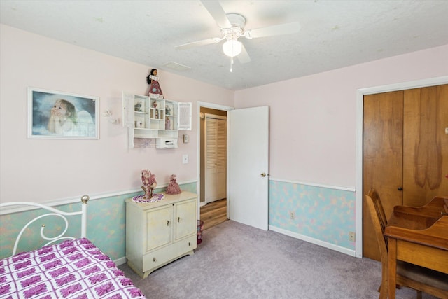 204 Crockett Dr, Quincy, MI 49082 - bedroom with light colored carpet, wainscoting, a ceiling fan, and wallpapered walls