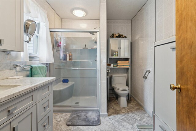 204 Crockett Dr, Quincy, MI 49082 - bathroom with tile walls, vanity, and a shower stall
