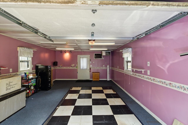 204 Crockett Dr, Quincy, MI 49082 - garage featuring a garage door opener and baseboards
