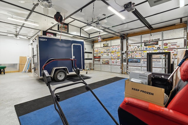 204 Crockett Dr, Quincy, MI 49082 - garage featuring ceiling fan and a garage door opener