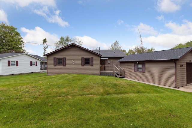 204 Crockett Dr, Quincy, MI 49082 - back of property with a lawn, a wooden deck, and roof with shingles