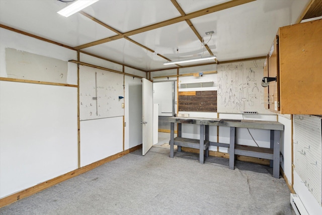 204 Crockett Dr, Quincy, MI 49082 - below grade area with a workshop area, carpet floors, and baseboard heating