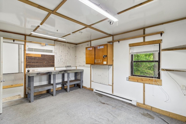 204 Crockett Dr, Quincy, MI 49082 - misc room featuring a workshop area, a baseboard heating unit, and light colored carpet