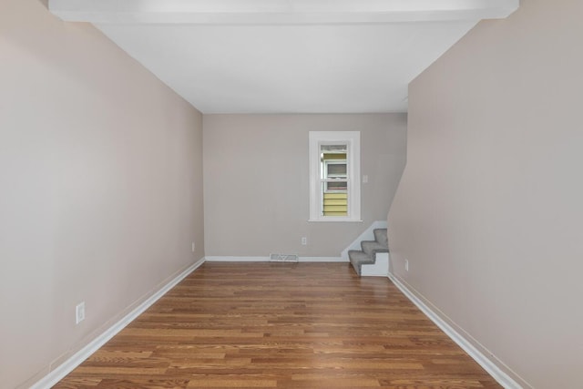 2069 Michael Ave SW, Wyoming, MI 49509 - spare room featuring stairway, wood finished floors, and baseboards