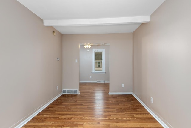 2069 Michael Ave SW, Wyoming, MI 49509 - spare room with beam ceiling, wood finished floors, and baseboards