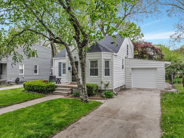 bungalow-style home featuring a shingled roof, a garage, a front lawn, and concrete driveway