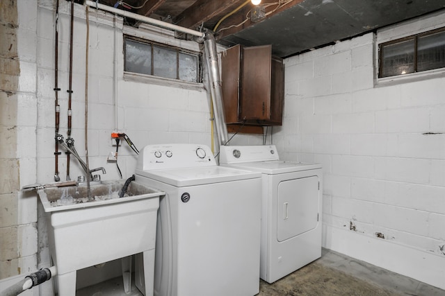 laundry area with washer and clothes dryer and a sink