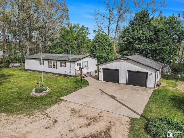635 Pokey Dr, Hastings, MI 49058 - view of front facade with an outdoor structure, a front lawn, and a detached garage