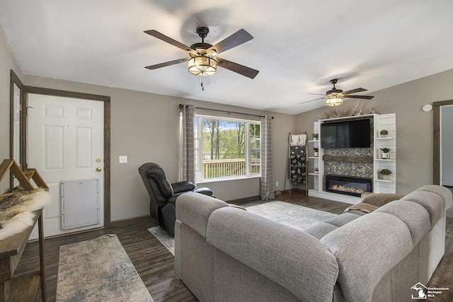 635 Pokey Dr, Hastings, MI 49058 - living area with ceiling fan, a glass covered fireplace, baseboards, and wood finished floors