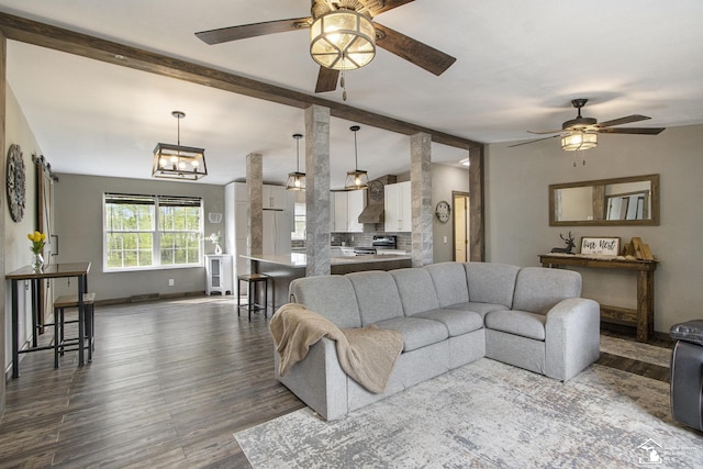 635 Pokey Dr, Hastings, MI 49058 - living room with a ceiling fan, dark wood-style flooring, beam ceiling, and baseboards