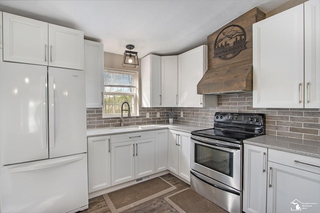 635 Pokey Dr, Hastings, MI 49058 - kitchen featuring freestanding refrigerator, stainless steel electric range, a sink, and white cabinetry