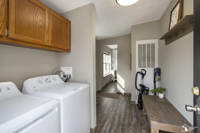 635 Pokey Dr, Hastings, MI 49058 - laundry room featuring washing machine and clothes dryer, cabinet space, dark wood-style floors, a heating unit, and baseboards