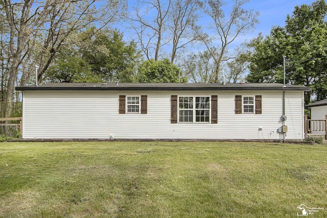635 Pokey Dr, Hastings, MI 49058 - back of house with a lawn