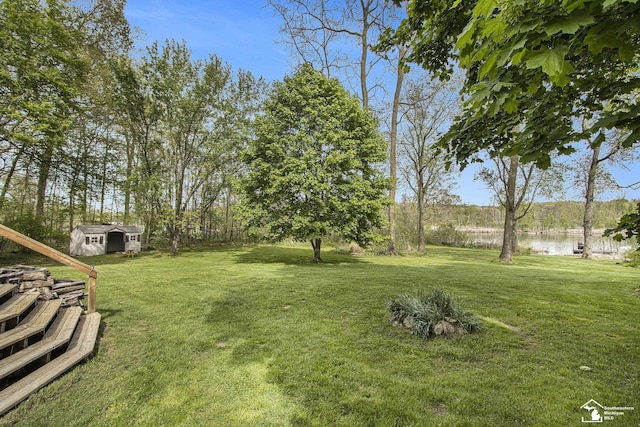 635 Pokey Dr, Hastings, MI 49058 - view of green lawn featuring a water view, an outbuilding, and a shed