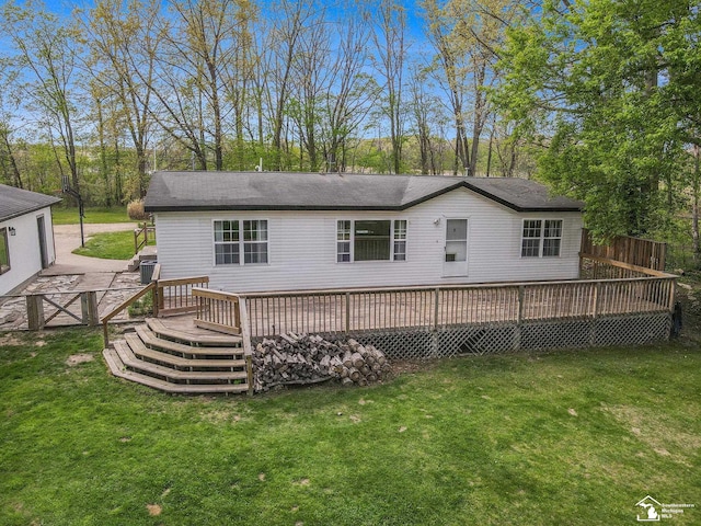 635 Pokey Dr, Hastings, MI 49058 - rear view of property with a deck and a yard