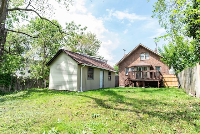 back of house with a deck and an outdoor structure