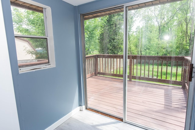 doorway featuring baseboards and healthy amount of natural light
