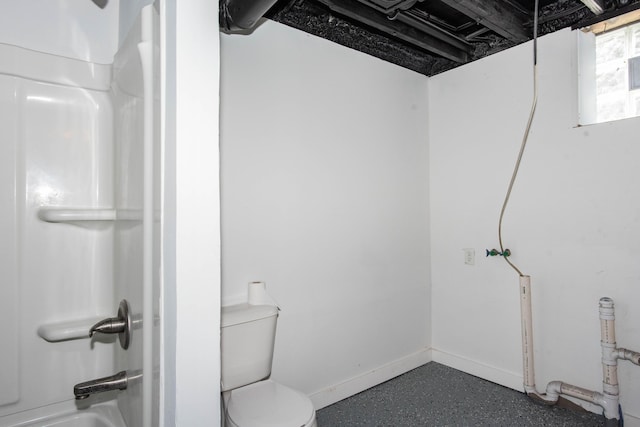 bathroom featuring toilet, shower / washtub combination, and baseboards