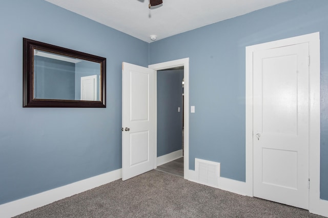unfurnished bedroom with carpet flooring and baseboards