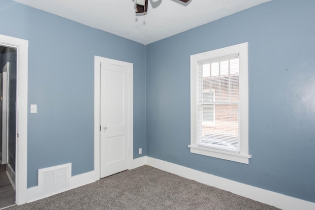 unfurnished bedroom featuring carpet, baseboards, and ceiling fan