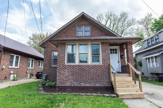 bungalow-style home featuring brick siding