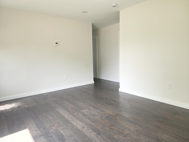 1301 Andrea St, Ypsilanti, MI 48198 - spare room with dark wood-style floors, baseboards, and a smoke detector