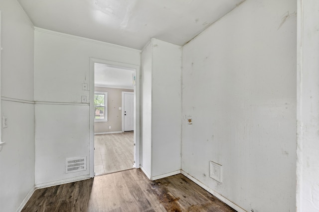 empty room featuring wood finished floors and baseboards