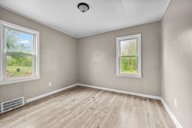 spare room with wood finished floors and baseboards