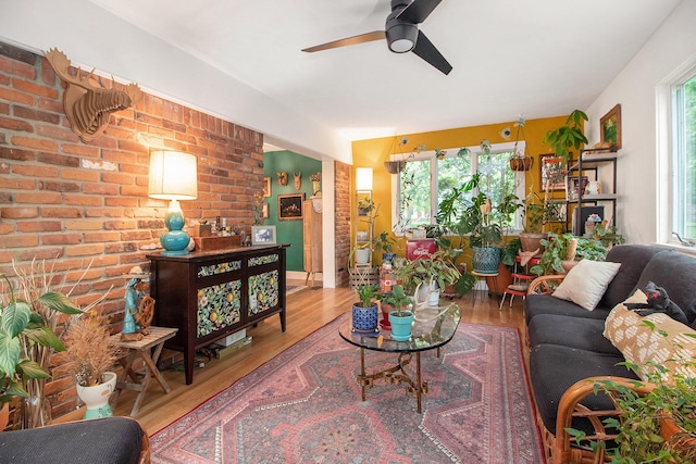 2454 Midvale Ave, Ypsilanti, MI 48197 - living area featuring ceiling fan, wood finished floors, and brick wall