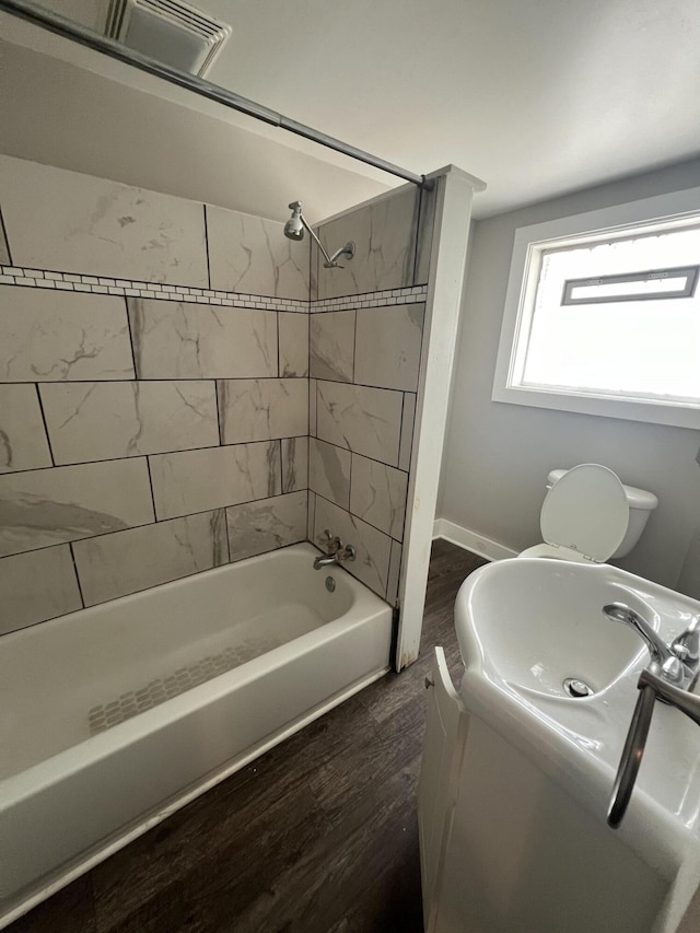 939 Baraga St NE, Grand Rapids, MI 49503 - bathroom featuring wood finished floors, washtub / shower combination, and vanity