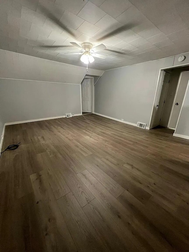 939 Baraga St NE, Grand Rapids, MI 49503 - bonus room with ceiling fan, dark wood-style floors, baseboards, and vaulted ceiling
