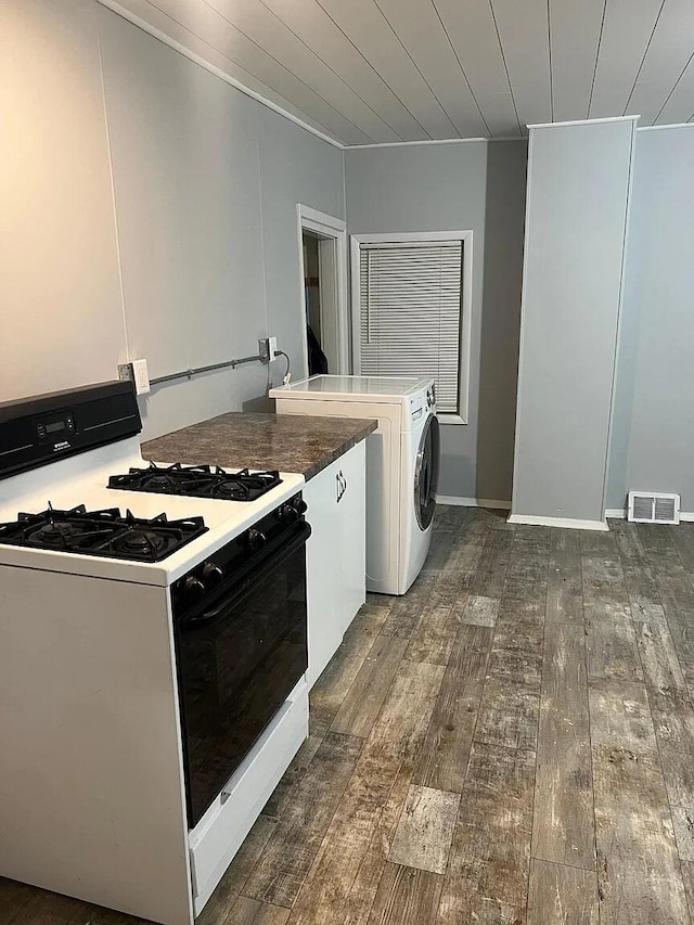 939 Baraga St NE, Grand Rapids, MI 49503 - kitchen featuring range with gas stovetop, dark wood finished floors, washer / dryer, white cabinets, and wood ceiling