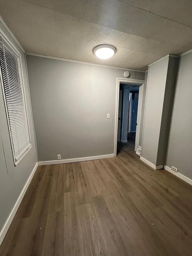939 Baraga St NE, Grand Rapids, MI 49503 - unfurnished room with wood finished floors, ornamental molding, and baseboards