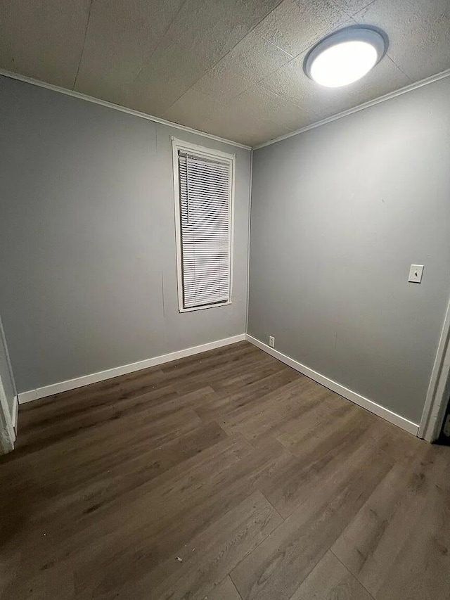 939 Baraga St NE, Grand Rapids, MI 49503 - empty room featuring dark wood-style flooring and baseboards